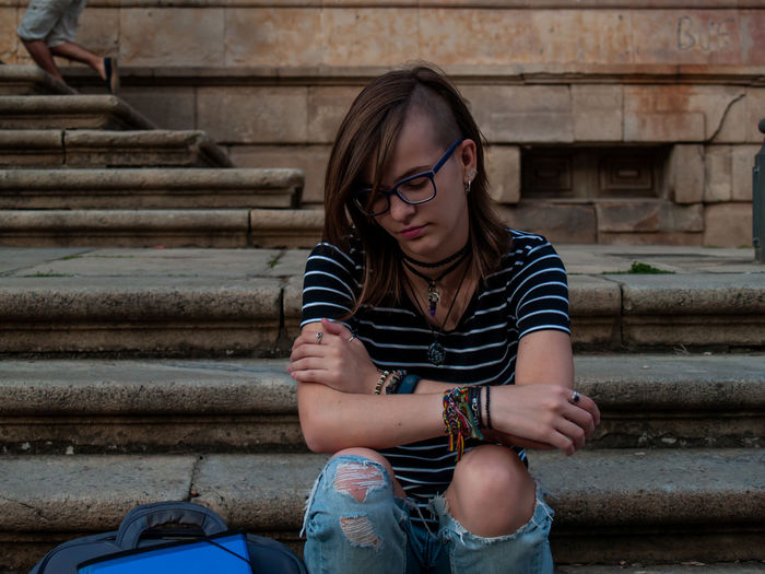 Teenage girl sitting on steps