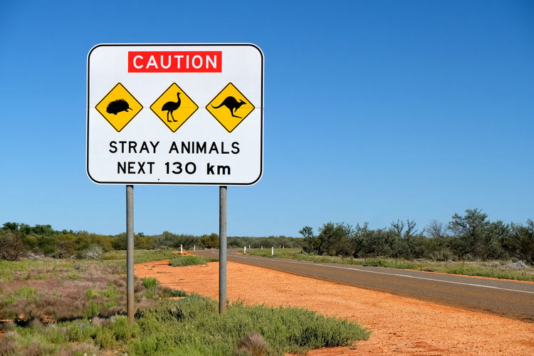 Road sign against blue sky