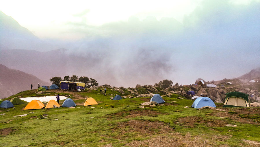 Panoramic view of tent on mountain against sky