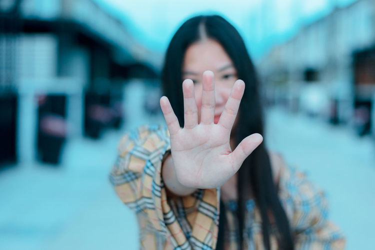 Young woman wearing casual clothes doing stop sing with palm of the hand. hand focus