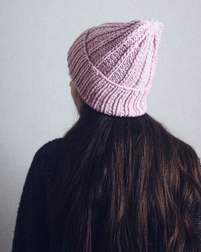 Rear view of woman wearing hat against white background