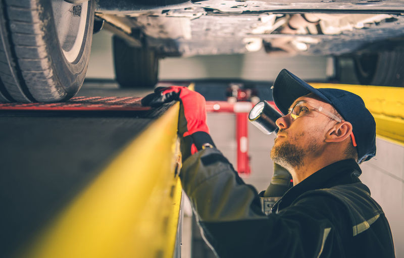 Close-up of mechanic working at garage
