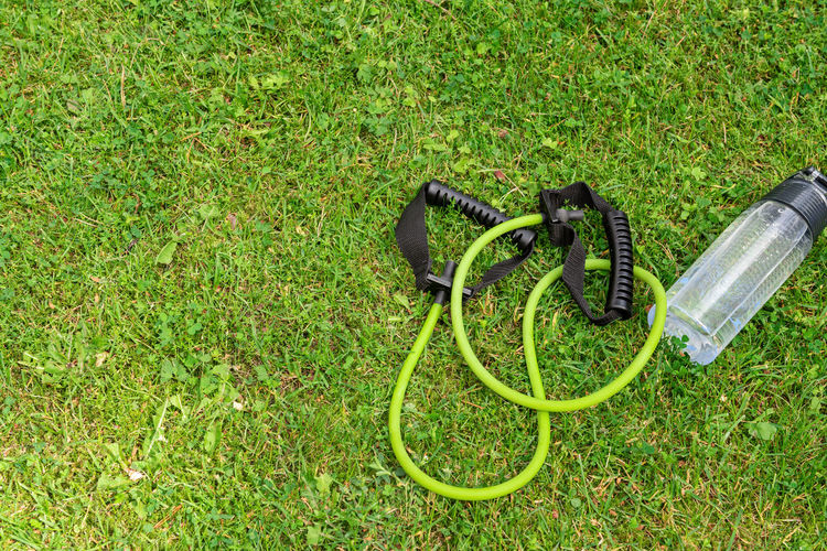 High angle view of in-ear headphones on grass