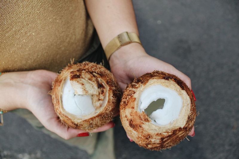 Close-up of woman holding coconuts
