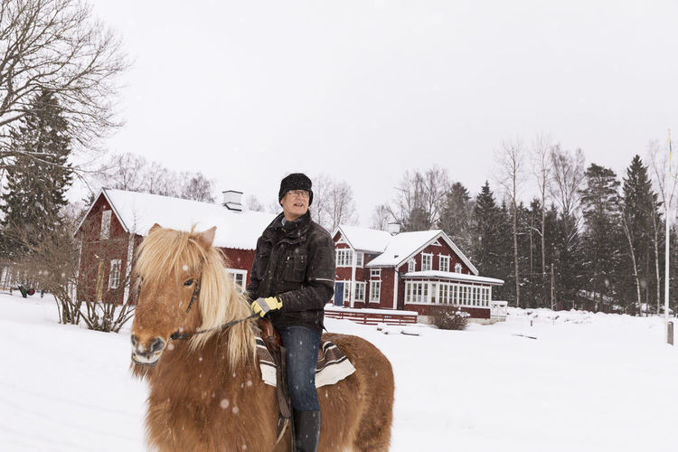 Senior man riding pony