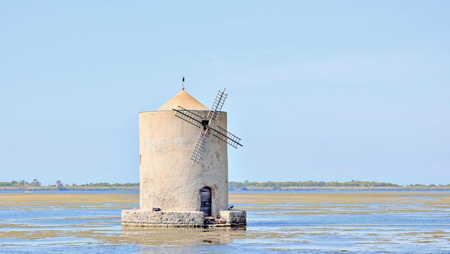 Lighthouse by sea against clear sky-orbetello 