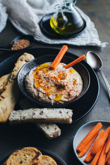 Delicious hummus with paprika, olive oil and some bread to dip