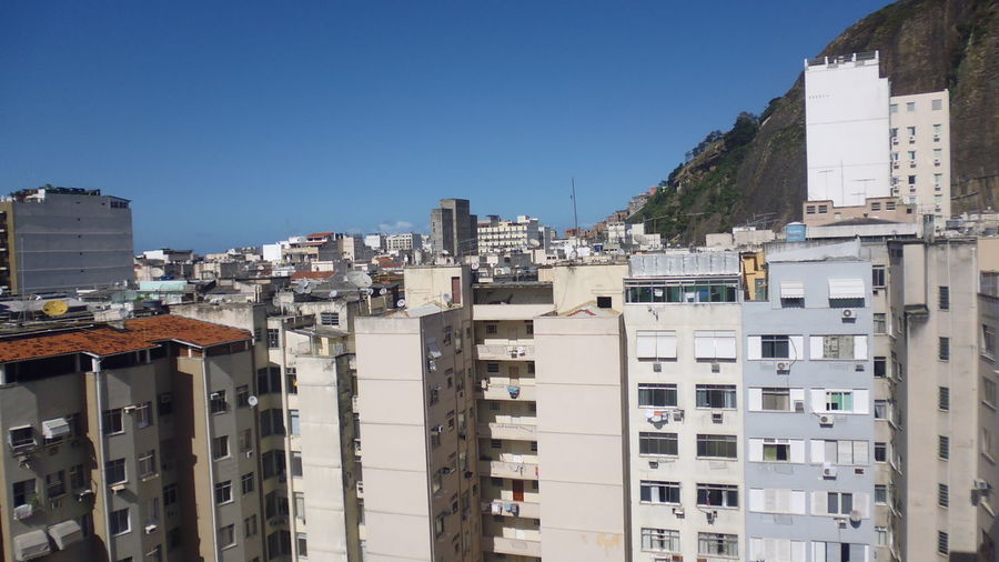 Cityscape against clear blue sky
