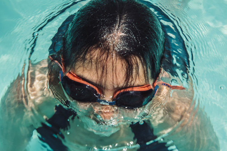 High angle portrait of girl swimming in pool