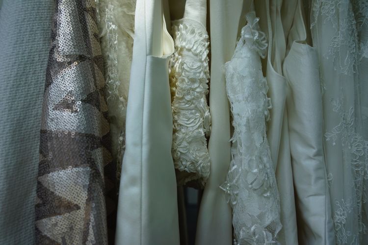 Full frame shot of dress arranged on rack in cupboard