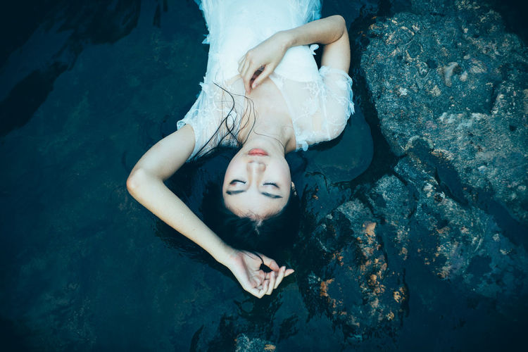 Portrait of young woman in water