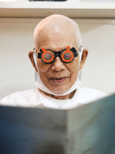 Portrait of old man having an eye check