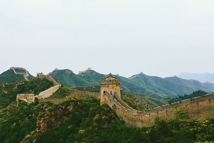 Great wall of china on green mountains against clear sky