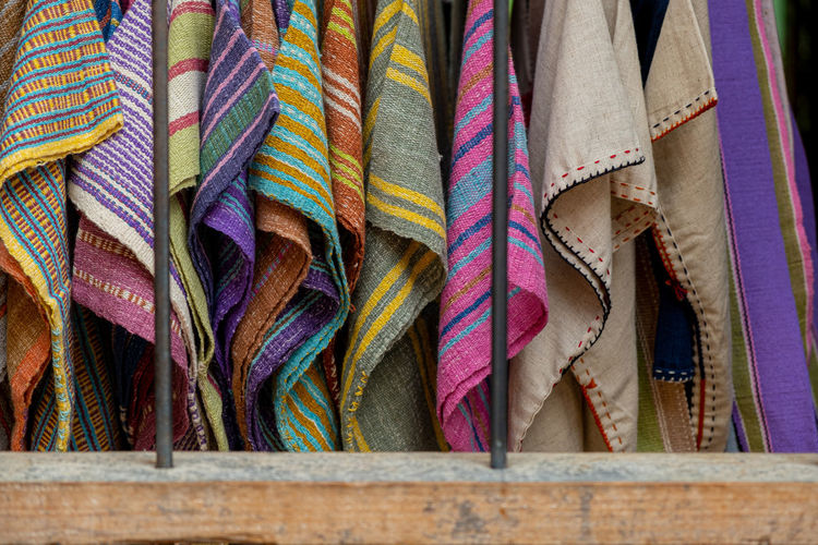 Low angle view of multi colored textiles hanging in store