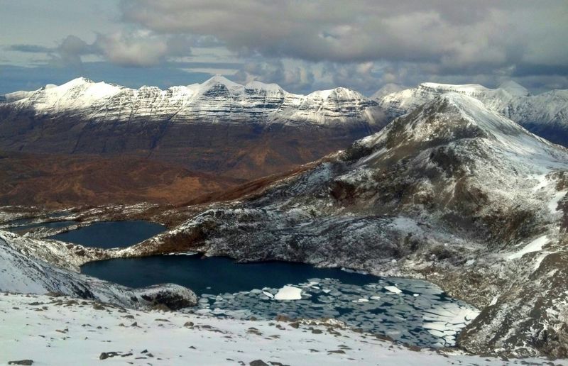Scenic view of snow covered mountains against sky