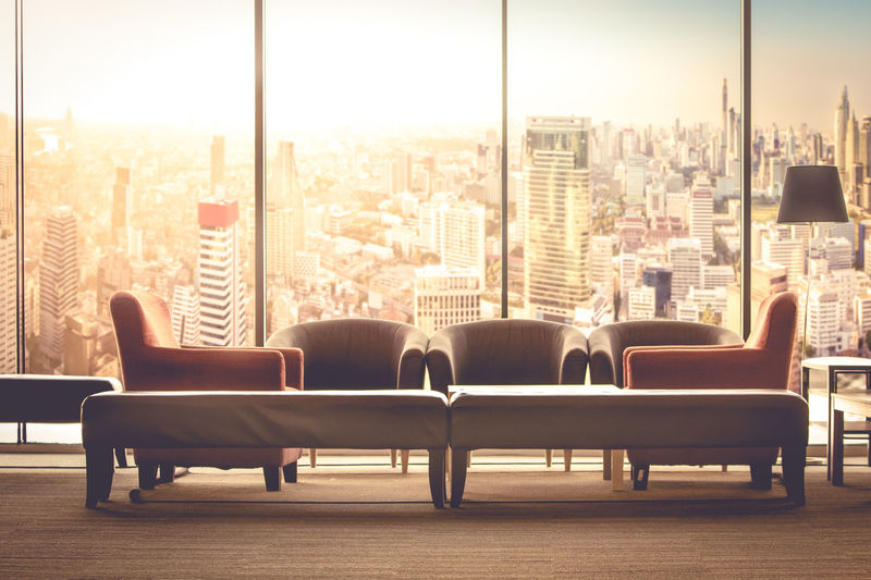 Chairs and table against buildings in city