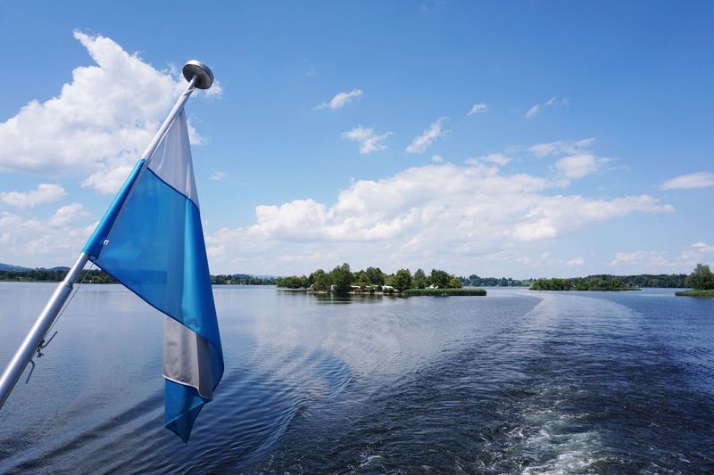 Sailboat in lake against sky