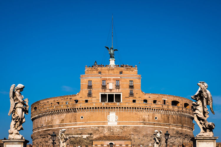 Statue of an angel carrying a cross on the sant angelo bridge in rome, italy
