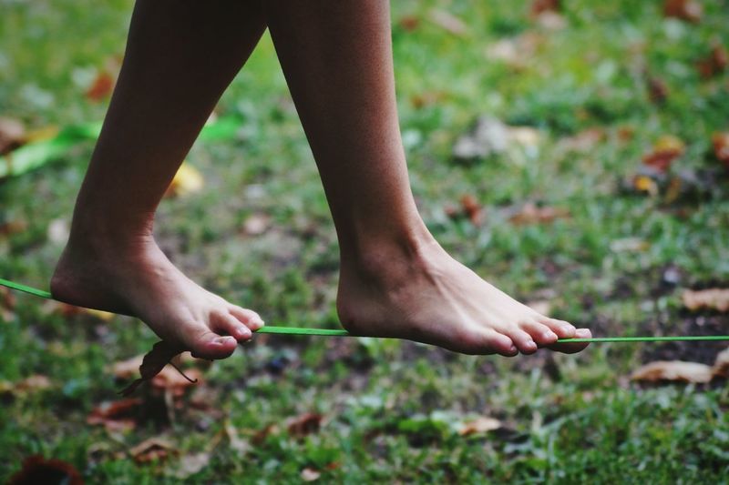 Low section of woman slacklining