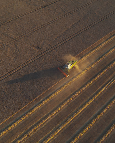 High angle view of agricultural field with harvester