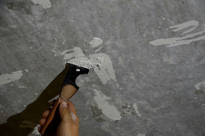 Cropped hand plastering wall