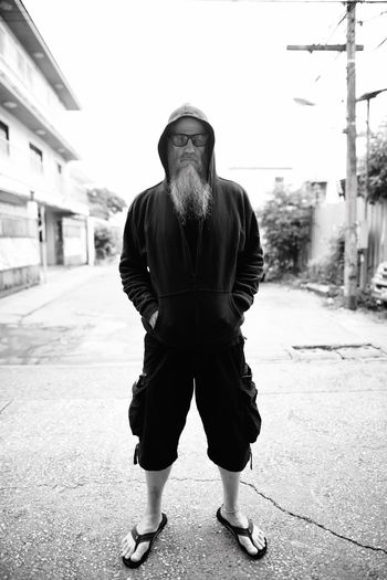 Full length portrait of man standing in city
