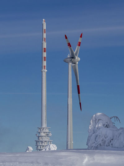 Traditional windmill against sky during winter