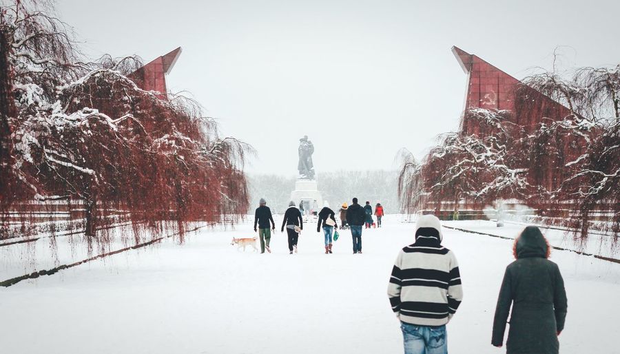 Rear view of people at treptower park during winter