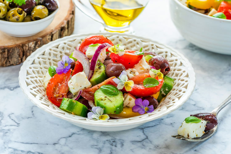 Traditional greek salad with fresh vegetables and feta cheese - healthy food idea
