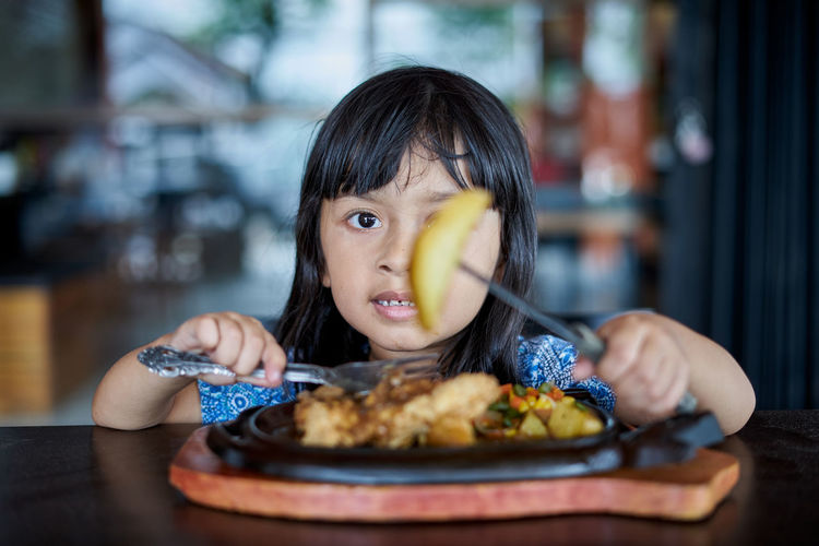 Portrait of girl eating food