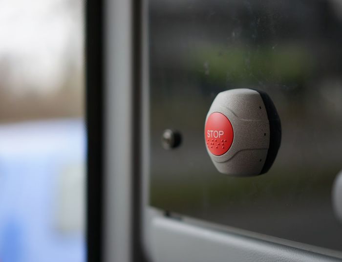 Close-up of stop button on glass window