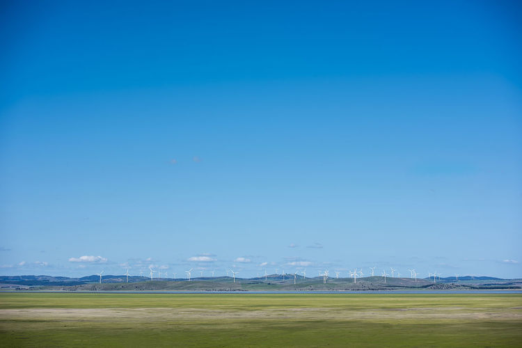 Scenic view of field against blue sky