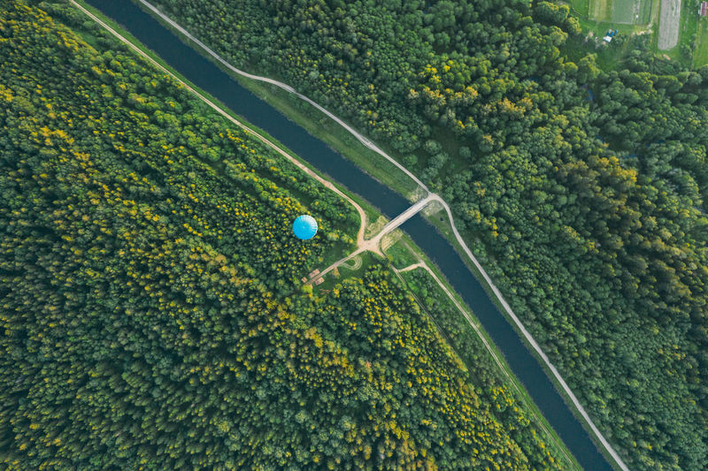 Air balloon over forests in a river.