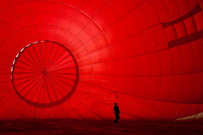 Air balloon pilot pre-flight checks in silhouette