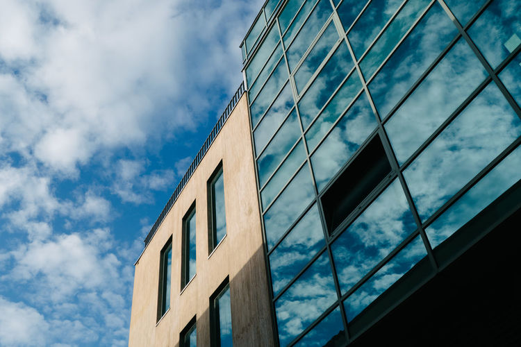 Low angle view of building against cloudy sky