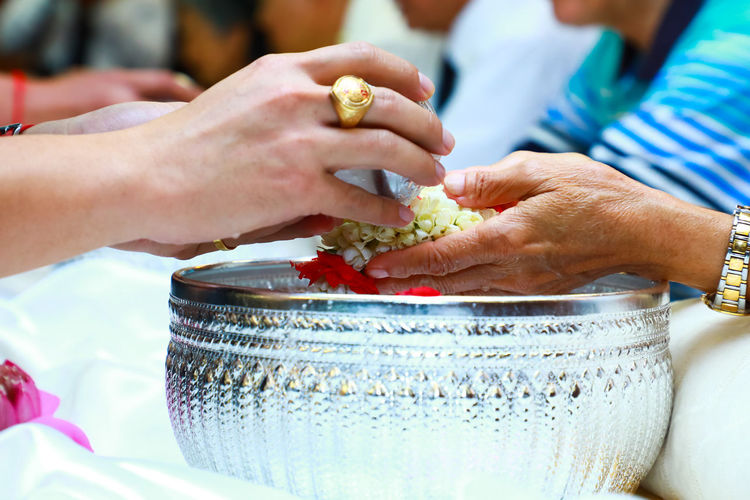 Cropped image of woman washing hands during traditional ceremony