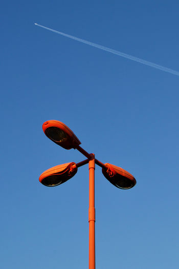 Low angle view of street light against clear blue sky