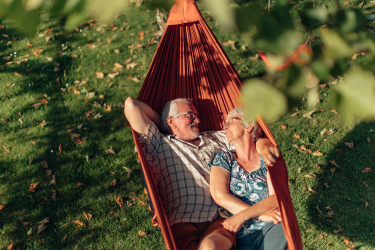 Senior couple bonding on the hammock. free time together. positive retired people.