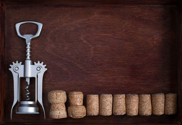 Directly above shot of corkscrew with corks on table