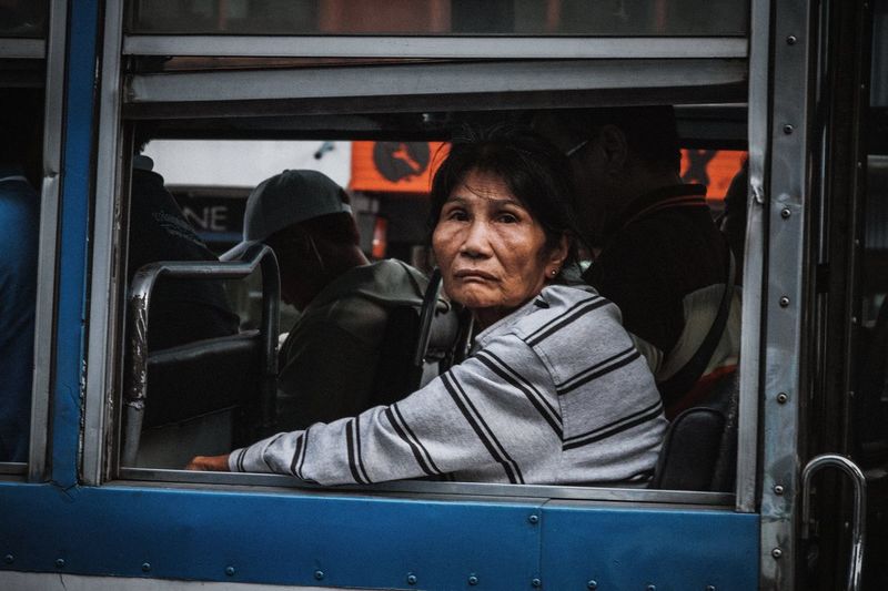 Portrait of mature woman sitting in bus
