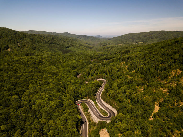 High angle view of winding road on landscape against sky