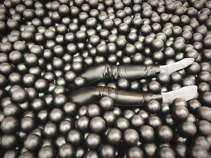 Low section of person amidst balls