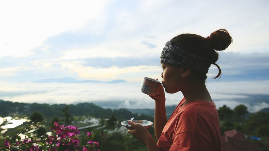 Close-up of woman drinking coffee outdoors