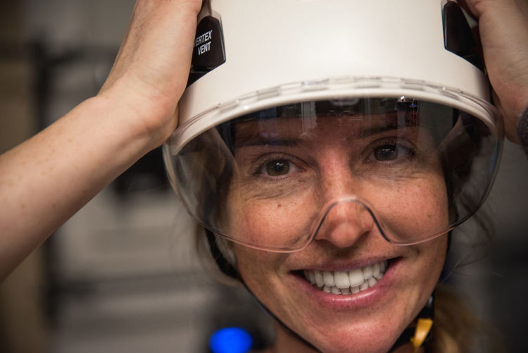 Close-up portrait of smiling woman in helmet