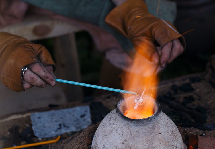 Close-up of glass blower making beads