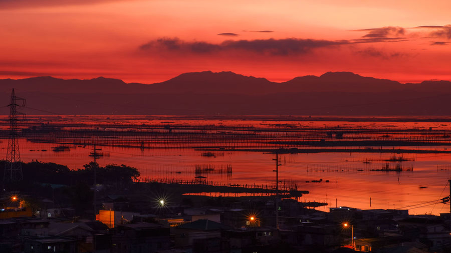 High angle view of illuminated buildings against sky at sunrise
