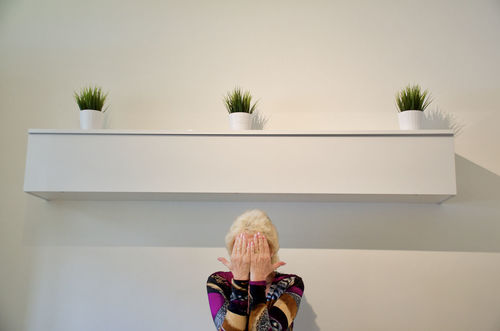 Woman covering face with hands