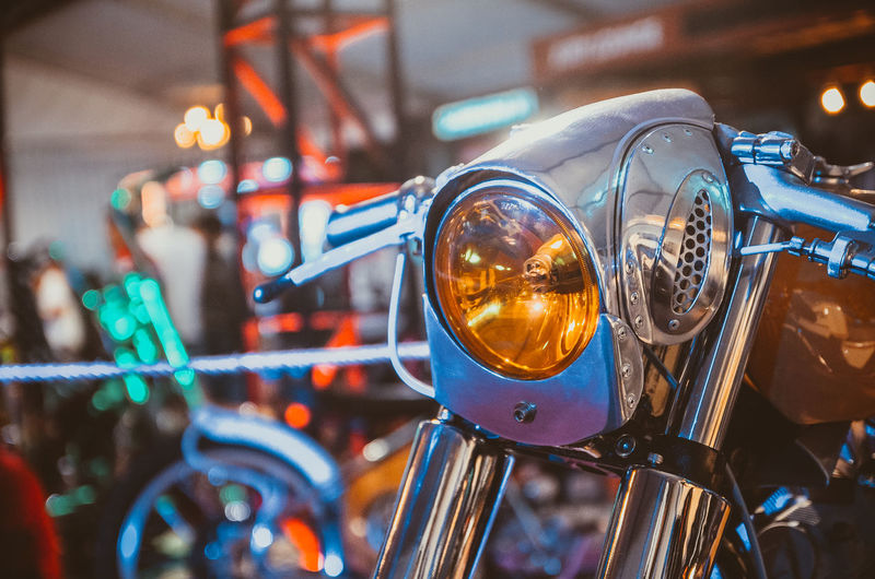 Close-up of illuminated motorcycle headlight
