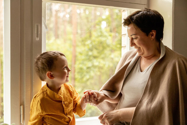 Happy grandmother and grandson enjoy time together. positive middle age woman 