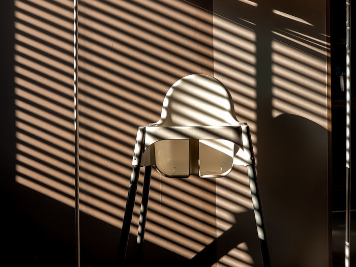Shadows in the interior, children's chair and shadow stripes.